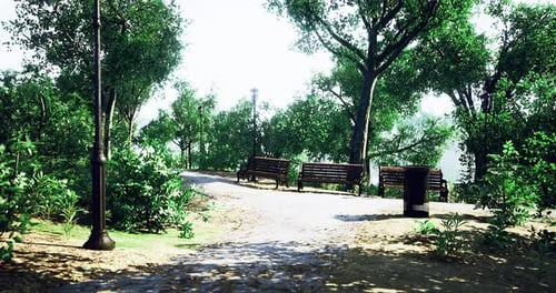 Serene Park Pathway with Benches and Greenery During Daylight Hours
