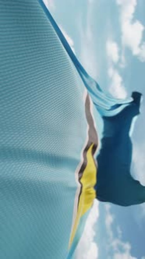 Saint Lucia Flag Waving in Blue Sky Vertical Video