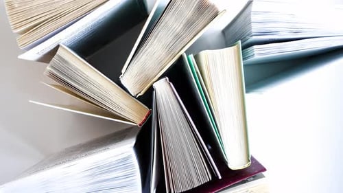 Stack of Open and Closed Books on White Background