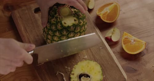 pineapple slices on a wooden base with nice knife
