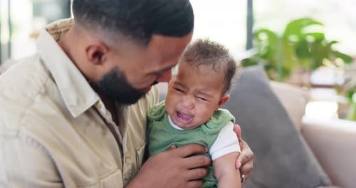 Comfort, crying and father with baby in home for bonding, relationship and console emotions