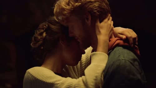 Intimate young couple embracing each other closely inside