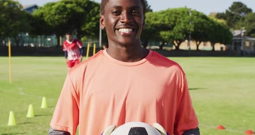 Video of african american male football players with ball on field