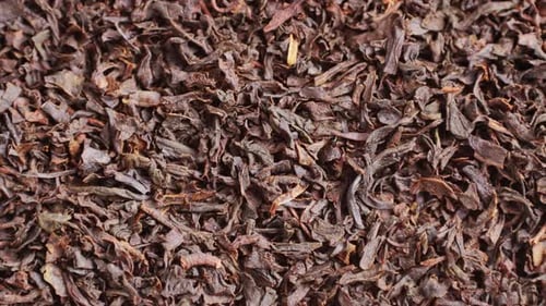 Earl Grey Close Up Leaf Tea Blend with Orange Blossom Petals on Dark Marble Board Macro Indian Sri