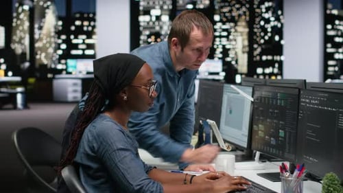 Software developers collaborate on project late at night