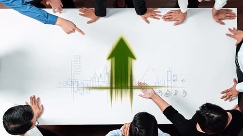 Business Team Discussing Financial Growth and Market Strategy, Analyzing Data on Conference Table wi