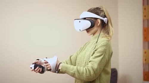 Woman Using Virtual Reality Headset and Controllers