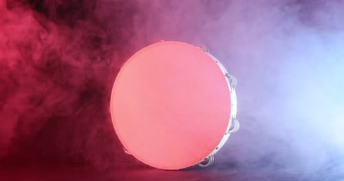 Tambourine Musical Instrument Lit with Red and Blue Smoke