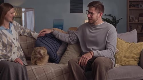 Playful Family Enjoying Time Together on Couch