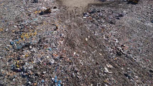 Aerial View of a Vast Landfill Where Bulldozers are Working and Trucks are Bringing New Waste Huge