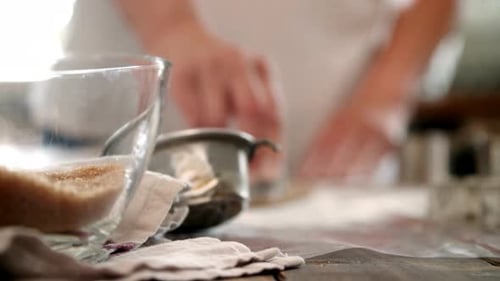 Woman Preparing Cookies with Cutters on Counter