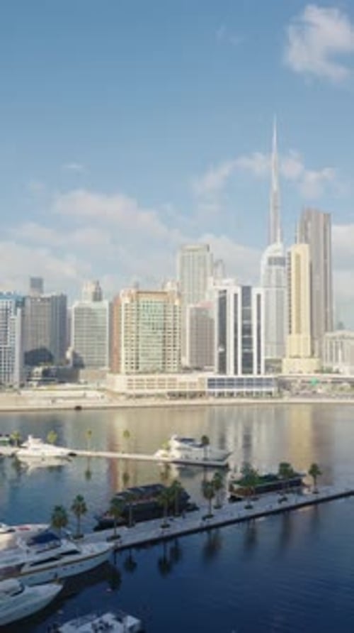 Vertical footage panoramic view of Dubai Business Bay on sunny day.