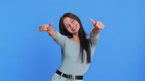 Young Woman Smiling and Giving Thumbs Up