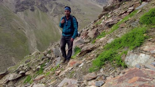 A Man Traversing across the Stony Path amid the Mountains