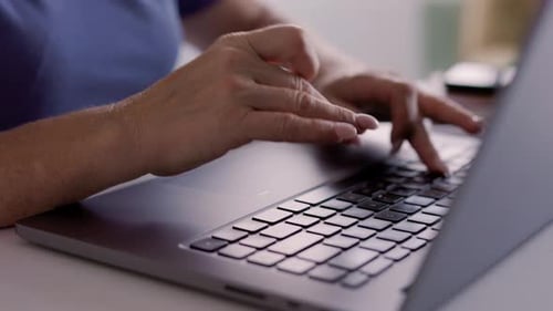 Close Up on Hands of Unrecognizable Woman Typing on Laptop Keyboard