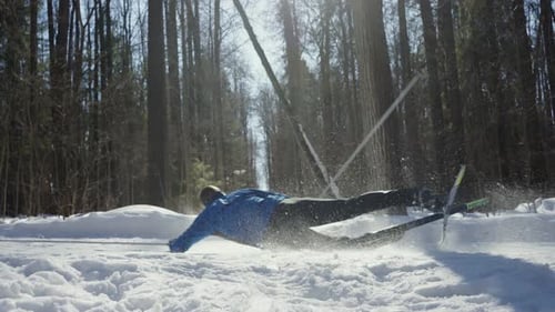 The Hard Fall of a Crosscountry Skier on a Snowy Track in the Middle of a Forest