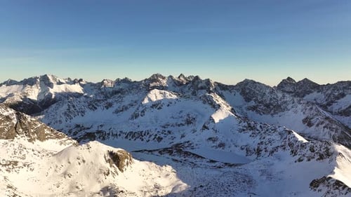 Breathtaking aerial views of the snow-capped Alps during clear skies