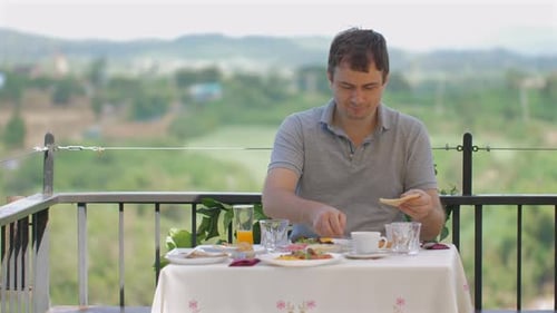 Man Enjoying Outdoor Dining Experience Alone at Scenic Restaurant with