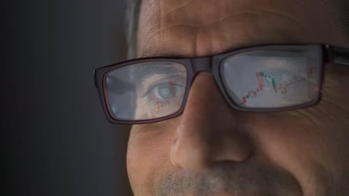 Trader analyzing charts in stock market. Rise in the Stock Market.