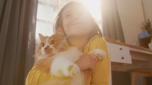 Low Angle Girl Lovingly Hugging Cat