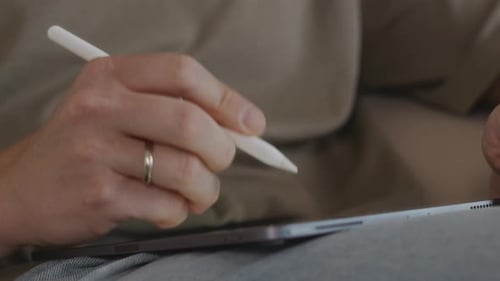Hand Using Stylus on a Tablet Device
