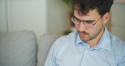 Young Adult Working at Home Looking Stressed