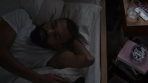 Man Lies in Bed Awake with Mobile Phone