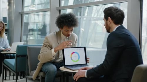 Businessmen Discuss Strategy in Modern Workplace