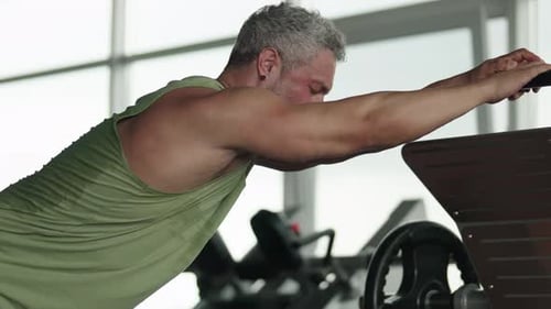 Man Stretching After Workout at the Gym to Relax Muscles