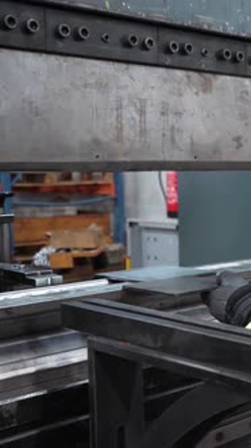 Man Working with Sheet Metal on Hydraulic Press Brake