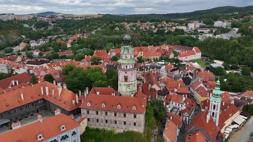 Český Krumlov, South Bohemia, Czechia, July 2023. Drone orbits the Historic Castle Tower surrounded