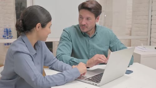 Office Colleagues Working Together on Laptop Computer