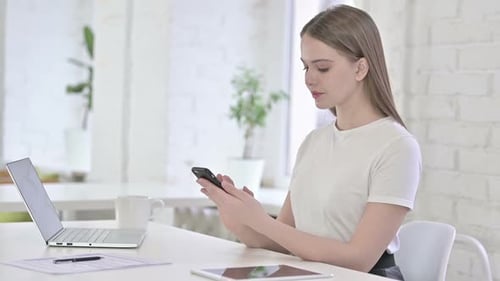 Excited Woman Celebrates with Smartphone