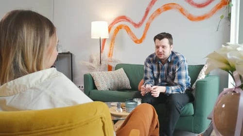 Man Talking with Woman in Living Room