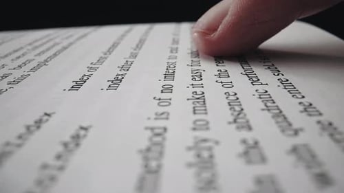 Cropped View of the Page with a Text in English and Forefinger Pointing Text While Reading Book