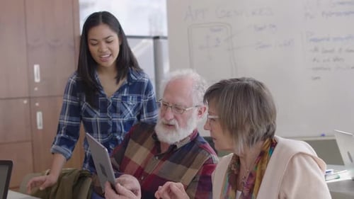 Woman Helps Seniors Use Touchscreen Tablet Technology