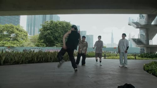Young Man Dancing Vigorously in an Urban Setting
