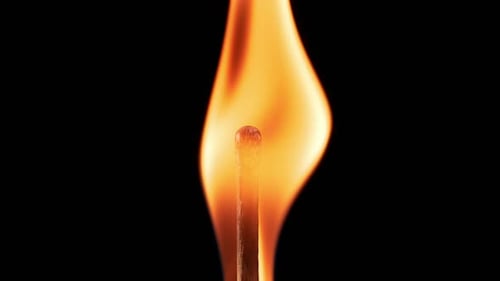 Burning Match Flame Detail on Black Background