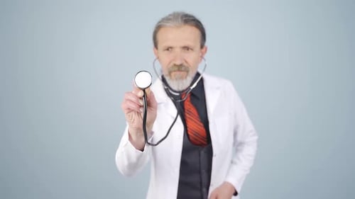 Doctor listening to camera with stethoscope.