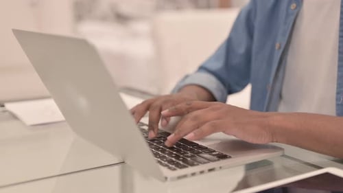 Close Up of African Man Working on Laptop