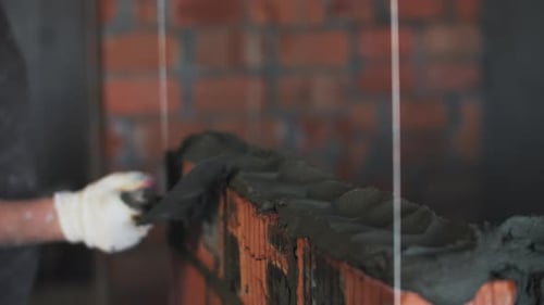 Builder Laying Red Brick Wall Spatula for Applying Cement Mortar