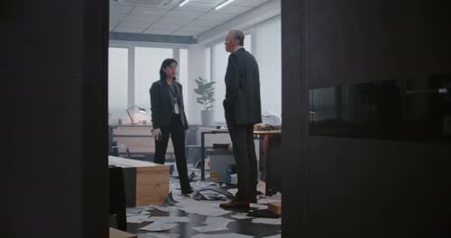 Investigators Examining Crime Scene in a Messy Office