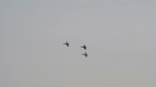 Fighter Jets Fly in Formation Through Gray Sky
