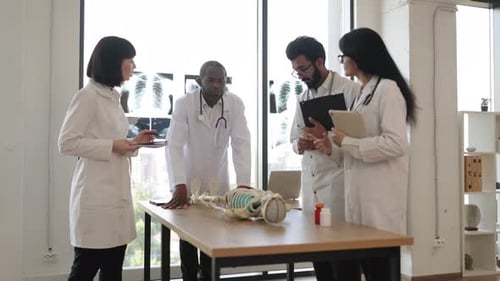 African Man Teacher Teaching Anatomy to University Students or Young Doctors
