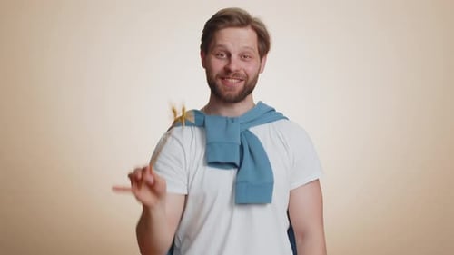 Man Holding Wand and Smiling in Studio