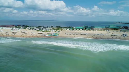 Aerial Over the Sandy Beach with Many People and Azure Water on a Summer Day Waves Crashing to the