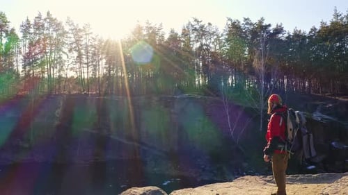 Drone View of a Man Stands on the Edge of a Cliff
