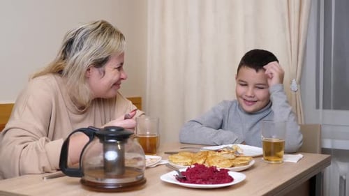 Adult and Child Chatting at Table Indoors