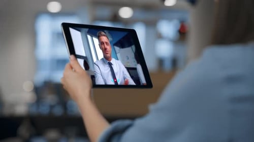 Online Coach Talking Video Conference with Unknown Woman Holding Tablet Close Up