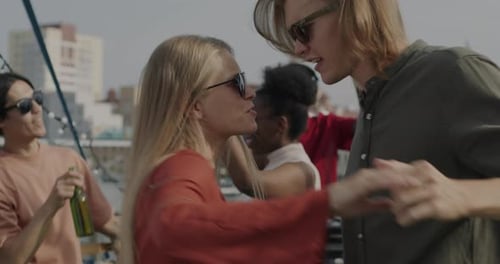 Friends Dancing on Rooftop on Sunny Day